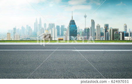 Road with green and cityscape skyline , morning scene . Road with green and cityscape skyline , morning scene . 62497031