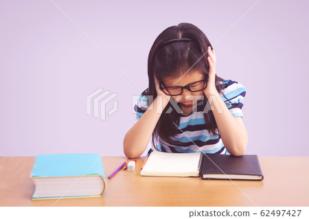 Bored and tired asian student girl doing homework 62497427
