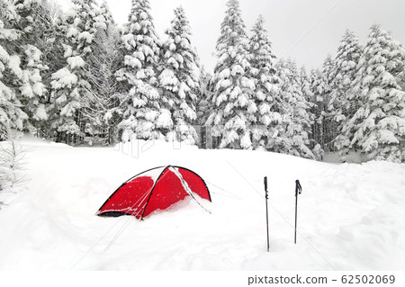 Red tent and hiking sticks, natural snow hill in Japan Yatsugatake mountains Red tent and hiking sticks, natural snow hill in Japan Yatsugatake mountains 62502069