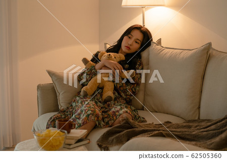 Lifestyle woman relax inside house 62505360
