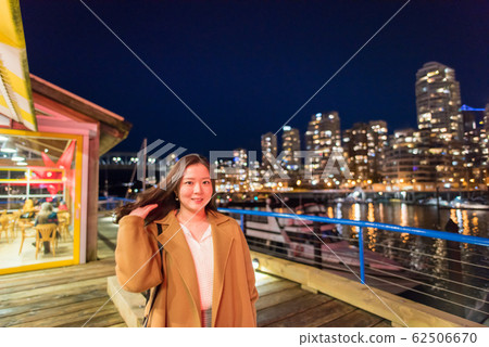 Woman enjoying the night view of Canada Woman enjoying the night view of Canada 62506670