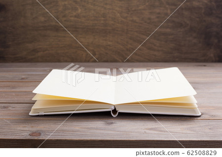 notepad or paper book at wooden table notepad or paper book at wooden table 62508829