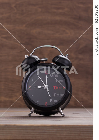 alarm clock at wooden table background alarm clock at wooden table background 62508830