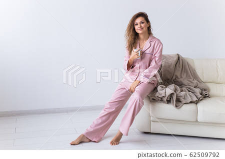 Glamorous girl with happy smile in good morning. Positive female model drinking hot tea 62509792