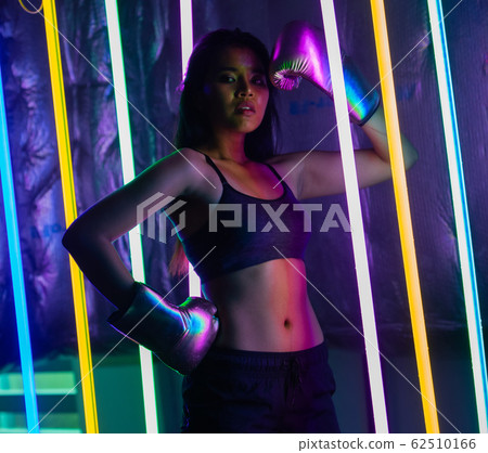 Beautiful 20s Asian Woman punch, poses with Silver Beautiful 20s Asian Woman punch, poses with Silver 62510166
