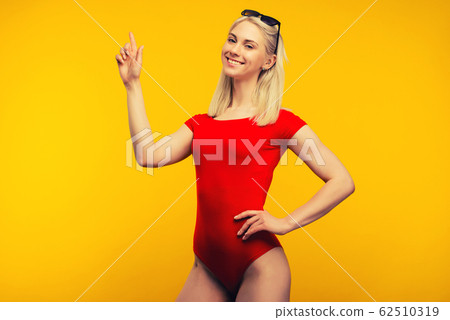 pretty blond lifeguard in red swimsuit and 62510319
