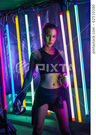 Beautiful 20s Asian Woman punch, poses with Silver 62510380