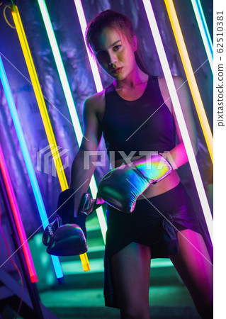 Beautiful 20s Asian Woman punch, poses with Silver 62510381