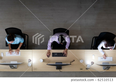 Call centre team night working top view Call centre team night working top view 62510513