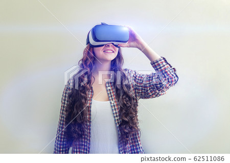Smile young woman wearing using virtual reality VR Smile young woman wearing using virtual reality VR 62511086