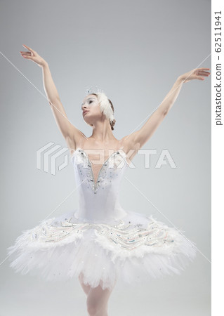 Close up of young graceful ballerina on white studio background 62511941