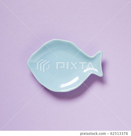 Fish shaped dish isolated on purple background Fish shaped dish isolated on purple background 62513378