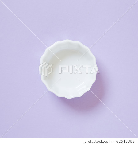 White dish isolated on purple background 62513393