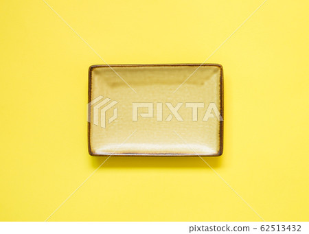 Yellow dish isolated on yellow background 62513432
