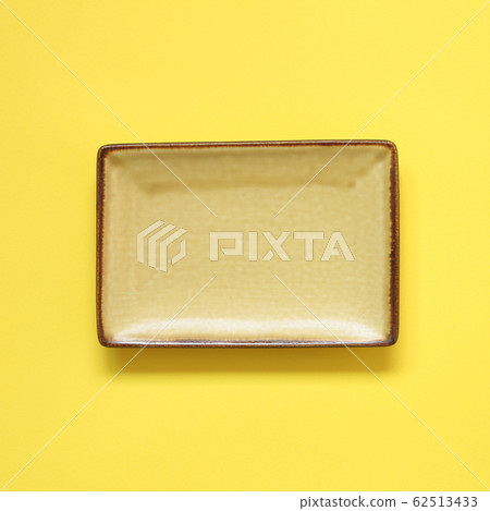 Yellow dish isolated on yellow background 62513433