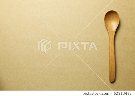 Wooden spoon on brown background Wooden spoon on brown background 62513452