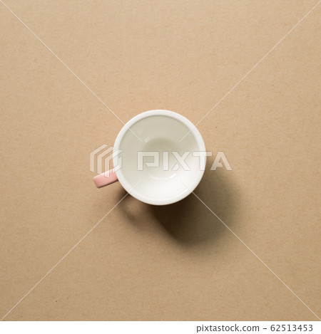 Empty mug cup on brown background Empty mug cup on brown background 62513453