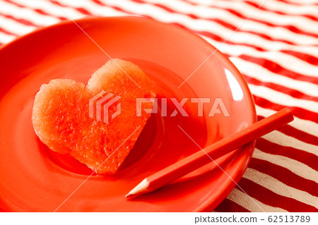 Heart shape fresh juicy watermelon on red dish Heart shape fresh juicy watermelon on red dish 62513789