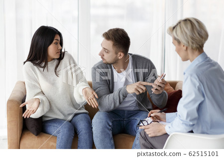 Husband Blaming Cheating Wife During Couples Therapy Session Indoor Husband Blaming Cheating Wife During Couples Therapy Session Indoor 62515101