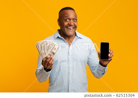 Mature african man holding lots of money and cellphone Mature african man holding lots of money and cellphone 62515304