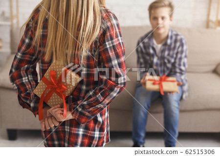Unrecognizable Girl Holding Gift For Brother Standing At Home, Cropped Unrecognizable Girl Holding Gift For Brother Standing At Home, Cropped 62515306