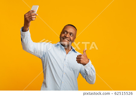 Modern african middle aged man making selfie Modern african middle aged man making selfie 62515526