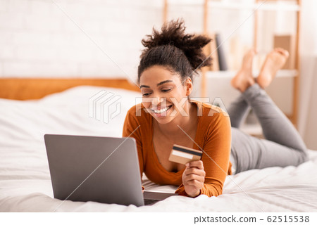 Lady Using Laptop And Credit Card Lying In Bed Indoor Lady Using Laptop And Credit Card Lying In Bed Indoor 62515538
