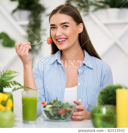 Diet concept. Young girl eating fresh vegetable salad Diet concept. Young girl eating fresh vegetable salad 62515541