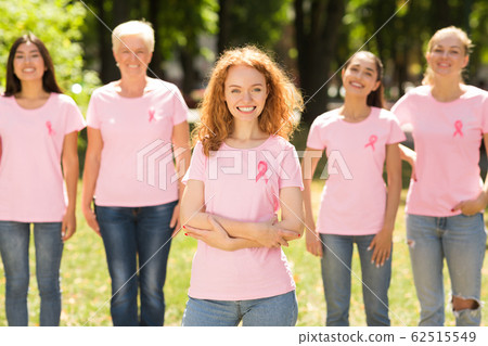 Breast Cancer Volunteer Standing With Group Of Women In Park Breast Cancer Volunteer Standing With Group Of Women In Park 62515549