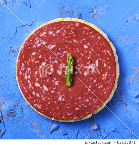 slice of veggie salami on a rice cake slice of veggie salami on a rice cake 62515871