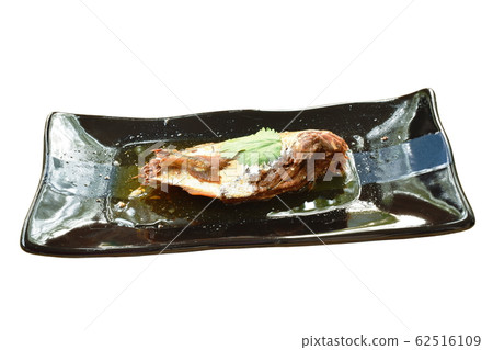 boiled salty mackerel fish in soy sauce soup on palte 62516109