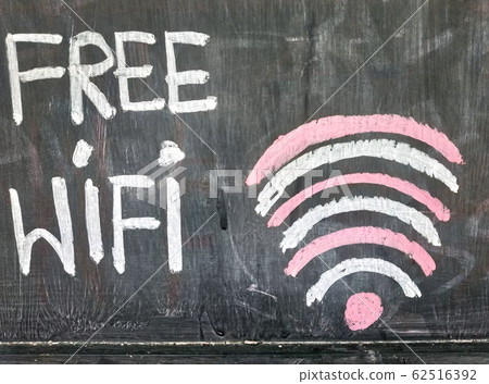 View text of free WIFI sign handwriting on black chalkboard. View text of free WIFI sign handwriting on black chalkboard. 62516392