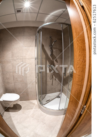 Mounted toilet bowl and shower in hotel room Mounted toilet bowl and shower in hotel room 62517613