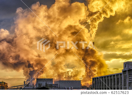 Air pollution from factory. Colorful smoke from chimneys and sunlight 62517623