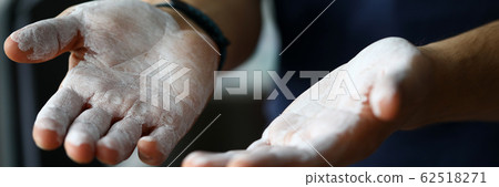 Male hands smeared with magnesium powder ready to workout Male hands smeared with magnesium powder ready to workout 62518271