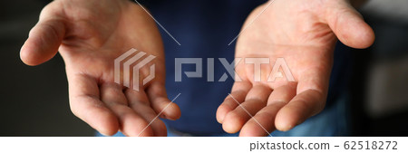 Man stretching empty hands with palms up to camera Man stretching empty hands with palms up to camera 62518272
