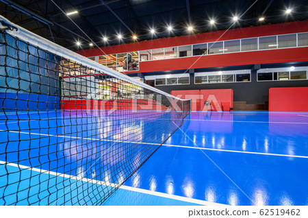 Blue colored empty indoor tennis court 62519462