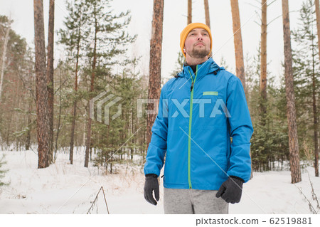 Enjoying winter stroll in forest Enjoying winter stroll in forest 62519881