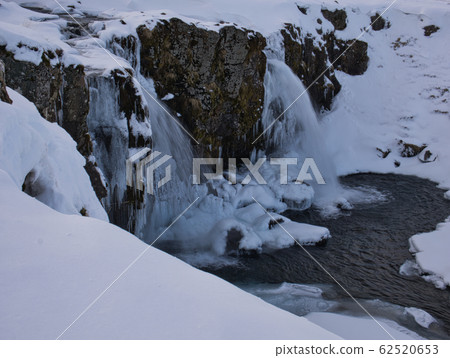 Waterfall in Iceland surrounded by snow and ice Waterfall in Iceland surrounded by snow and ice 62520653