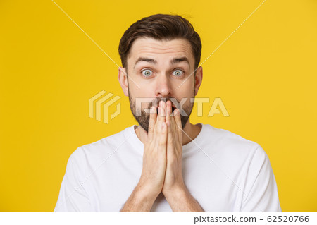 young bearded man looking amazed in to the camera young bearded man looking amazed in to the camera 62520766