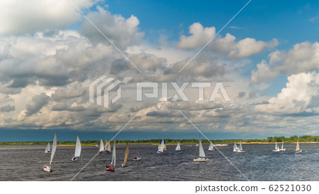 Sailing yachts at sport regatta competition race on river Sailing yachts at sport regatta competition race on river 62521030