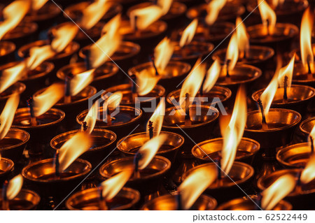 Burning candles in Buddhist temple 62522449