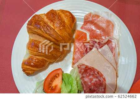 Croissant with cured meat and ham on plate for breakfast Croissant with cured meat and ham on plate for breakfast 62524662