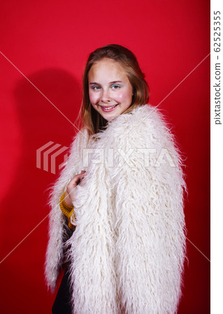 young pretty teenage girl on bright red background, happy smiling lifestyle people concept young pretty teenage girl on bright red background, happy smiling lifestyle people concept 62525355