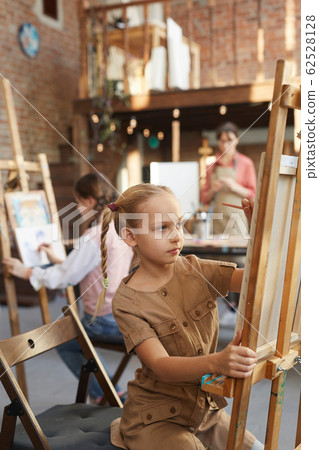 Girl sitting at art studio Girl sitting at art studio 62528128