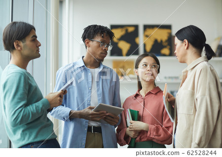 Young people standing at office Young people standing at office 62528244