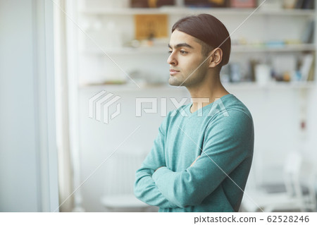Pensive man standing at office 62528246