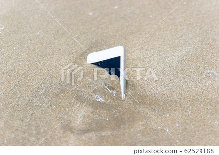 Mobile phone floated to the sea at the beach. 62529188