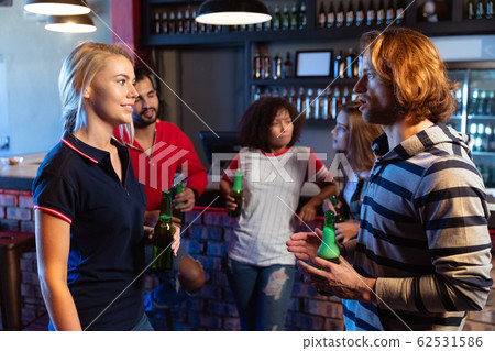 Friends discussing together while drinking 62531586