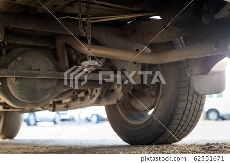 Spare tire wheel stored under the car were stolen,spare wheel has been lost,car missing tire,stolen tire in the parking car,concept of burglary insurance,theft,larceny,criminal,problems of junkie 62531671